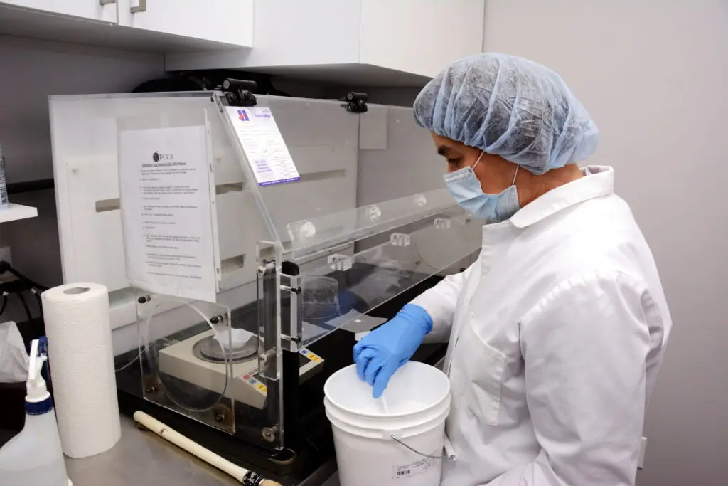 Female Compounder at Work