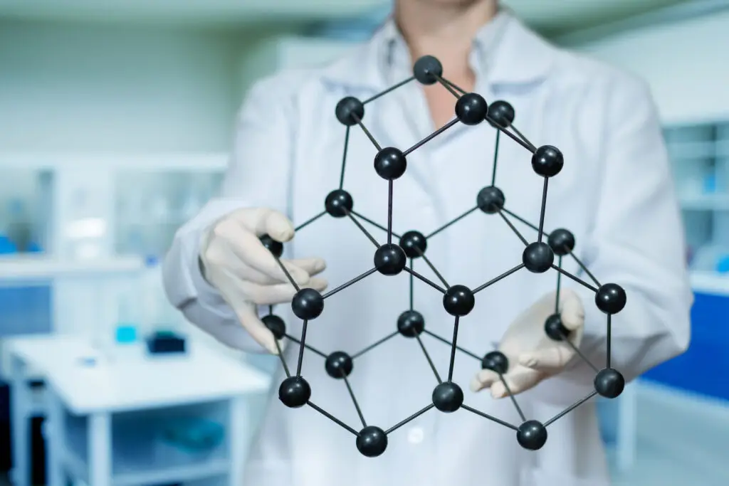 Scientist studies molecules in lab.