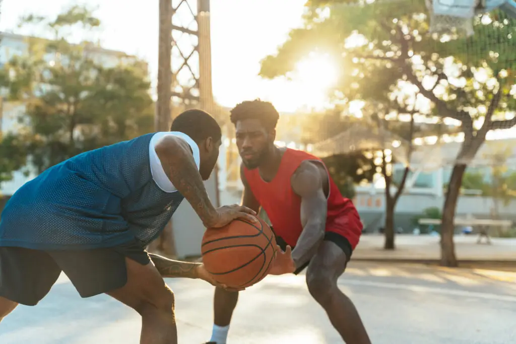 Young basketball players training at the court.